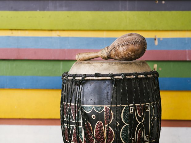 percussion-instruments-alongside-multicolored-stripes-wall-with-copy-space.jpg