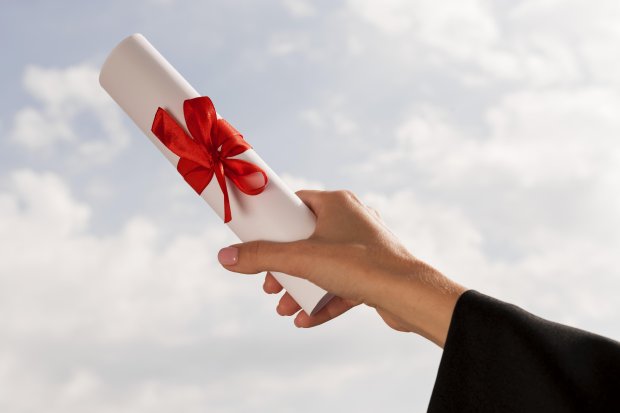 certificate-with-ribbon-bow-held-hand.jpg